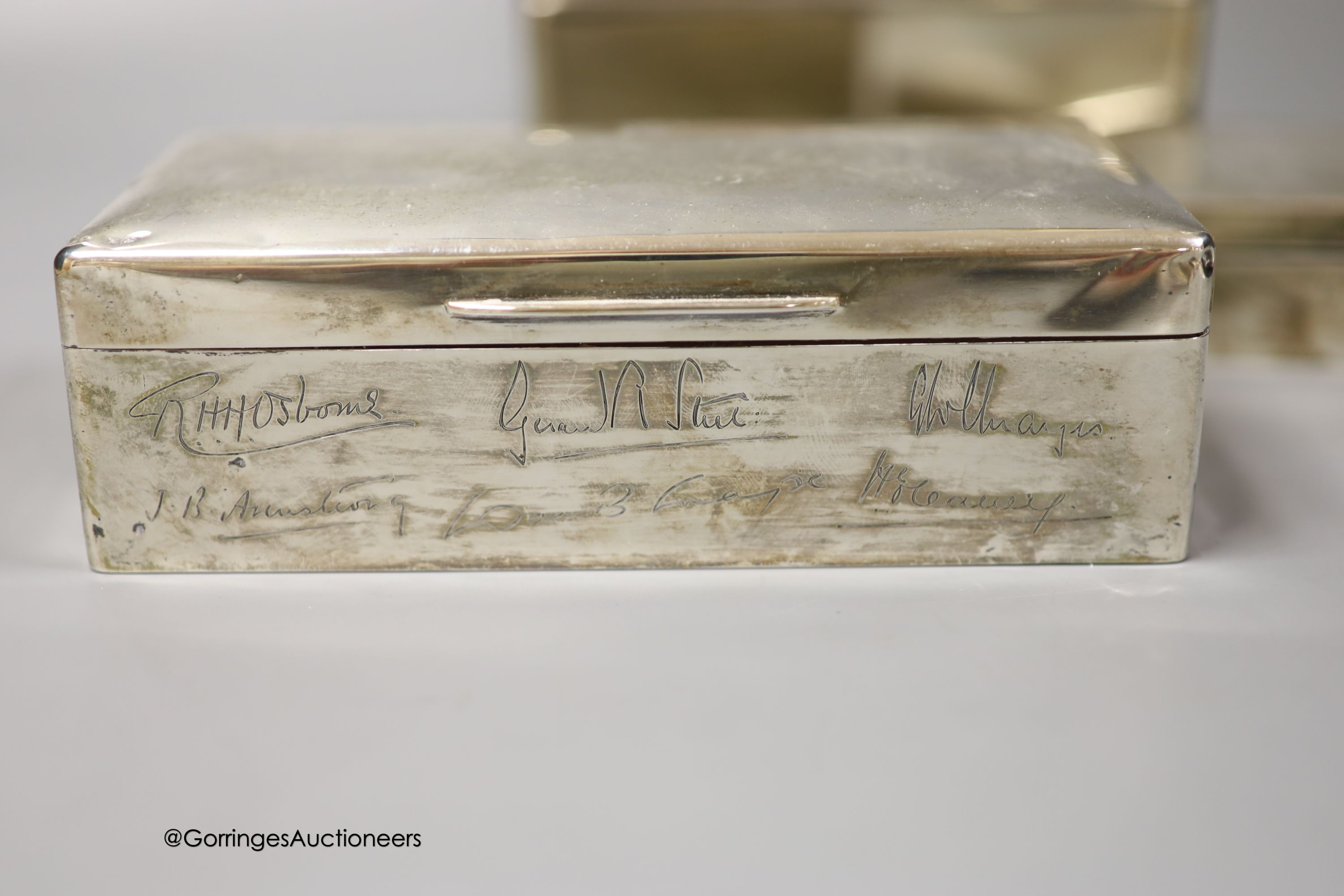 Three 20th century silver mounted cigarette boxes, two with engraved signatures, largest 16.2cm.